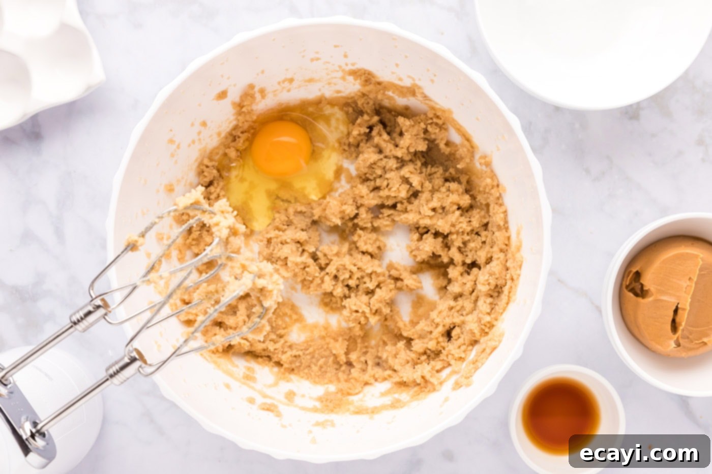 Sweet & Salty Fluffernutter Delights 7 mixing peanut butter cookie dough ingredients in a bowl with an electric mixer