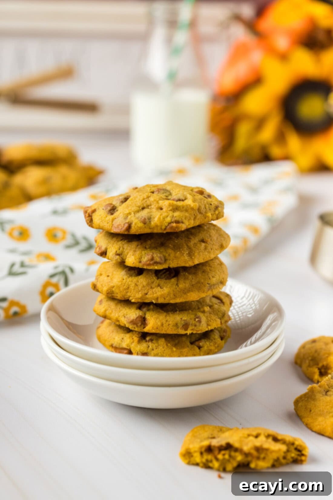 Spiced Pumpkin Cinnamon Chip Cookies 3 A stack of perfectly baked pumpkin cinnamon chip cookies on a cooling rack, highlighting their golden-brown edges and soft centers.