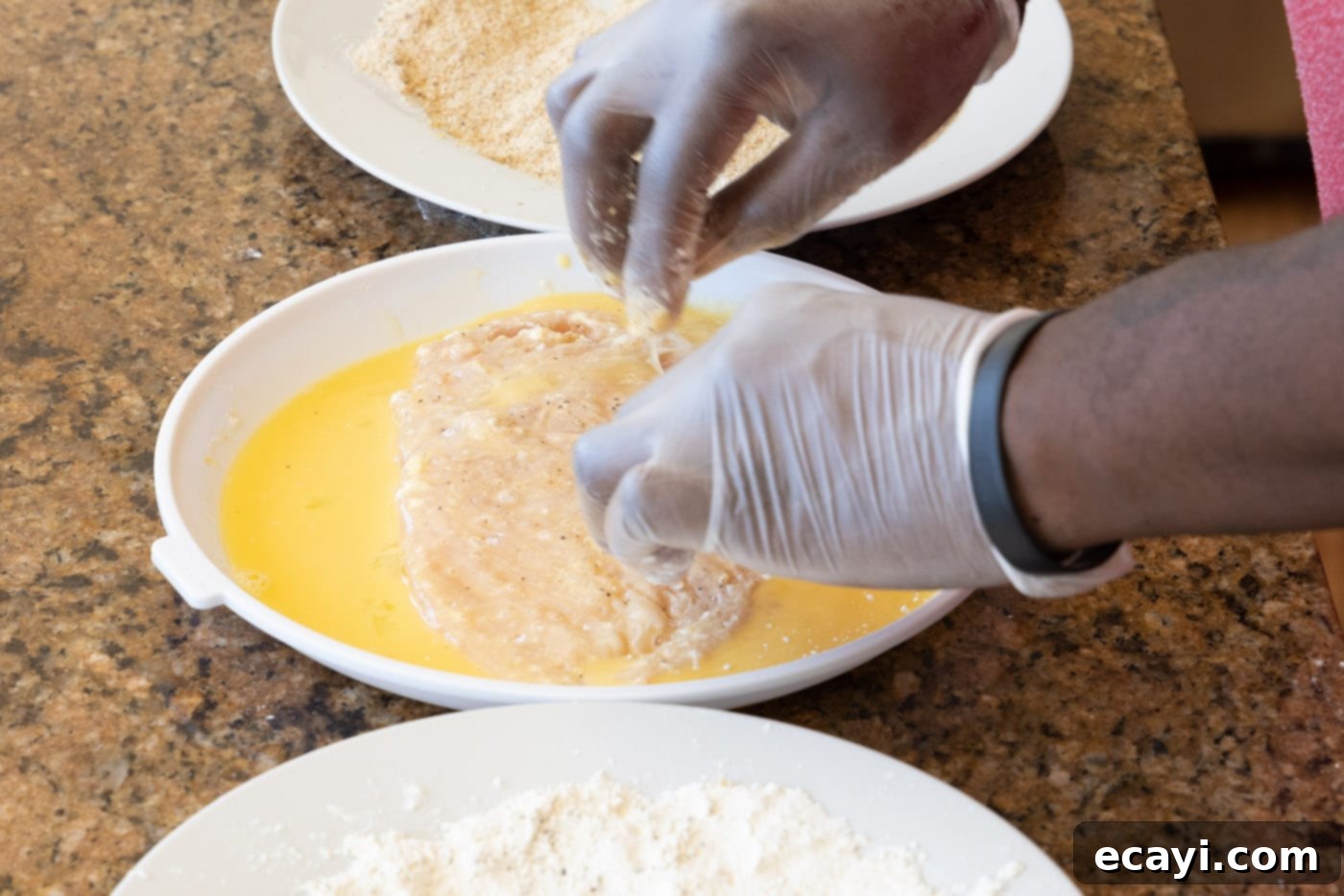Crispy Chicken Milanese 10 Dredging a flour-coated chicken cutlet in egg mixture