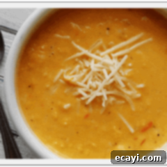 Velvety White Cheddar Corn Chowder 2 A close up photo of a bowl of creamy white cheddar corn soup.