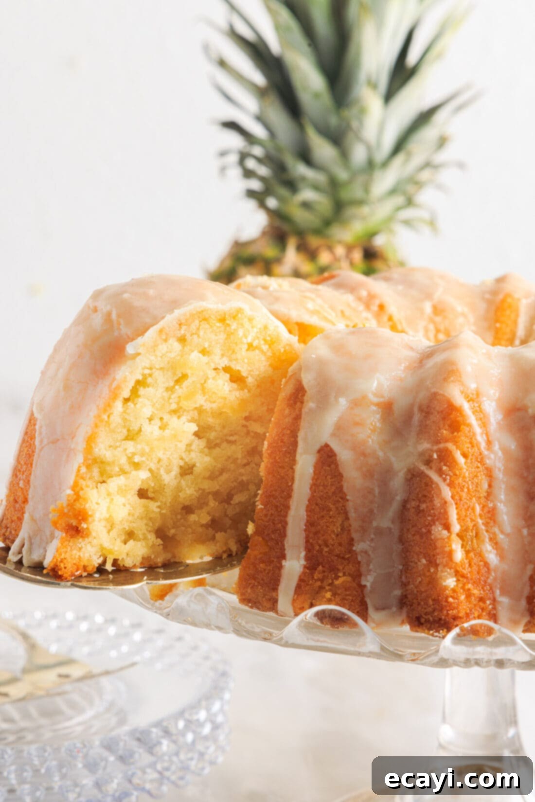 Sunshine Pineapple Pound Cake 2 A perfectly sliced Pineapple Pound Cake, showcasing its moist interior and golden crust, topped with a delicate vanilla pineapple glaze.
