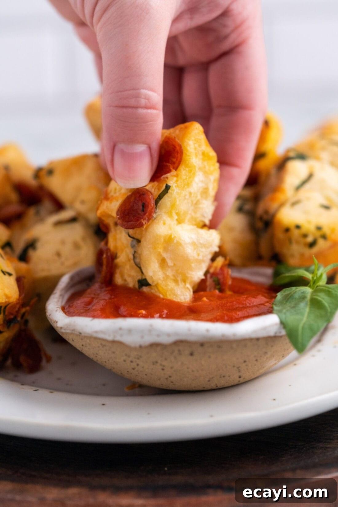 Pizza Bites 2 dipping a pizza bite in marinara