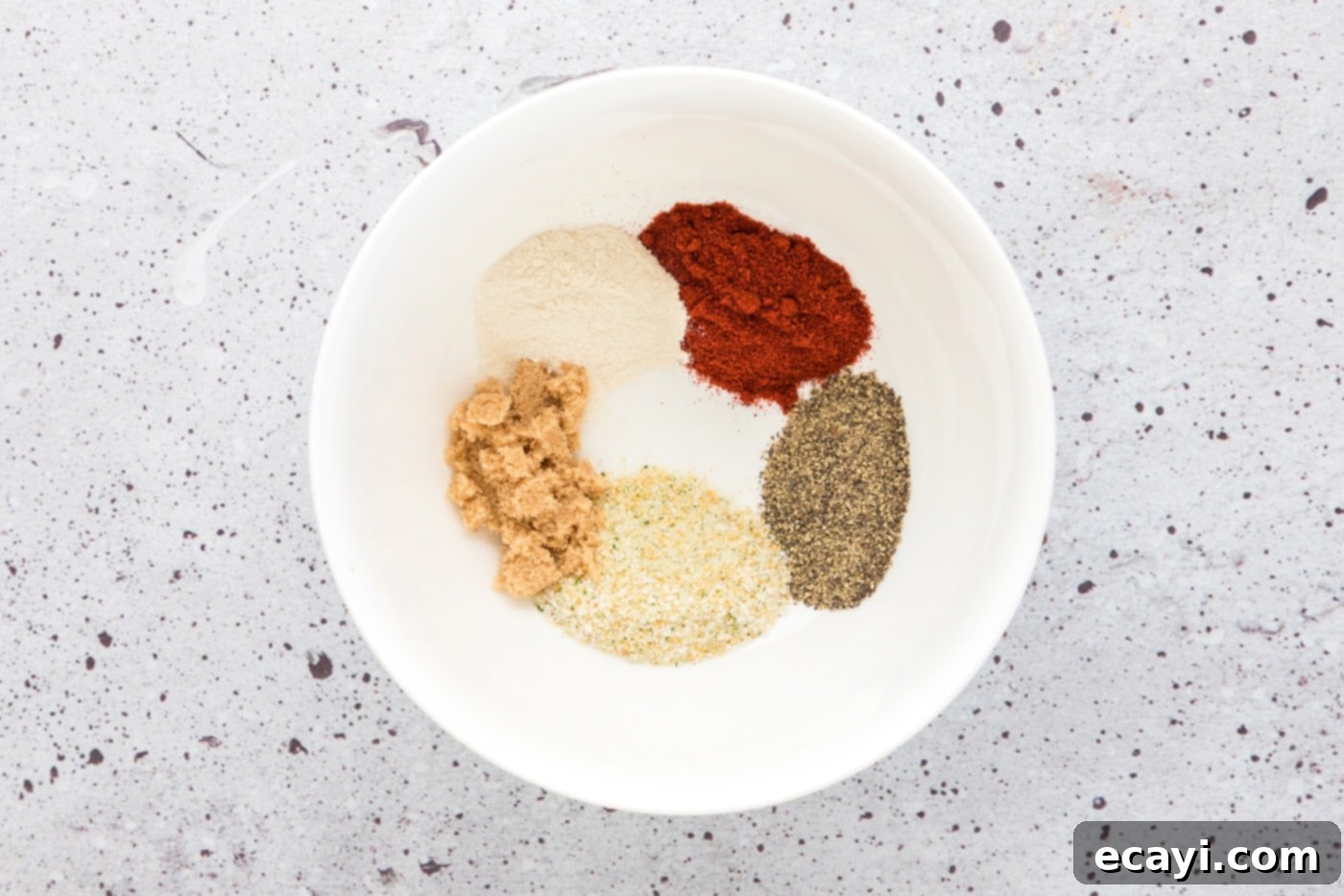 Golden Baked Chicken Thighs 5 seasoning rub for chicken in a bowl