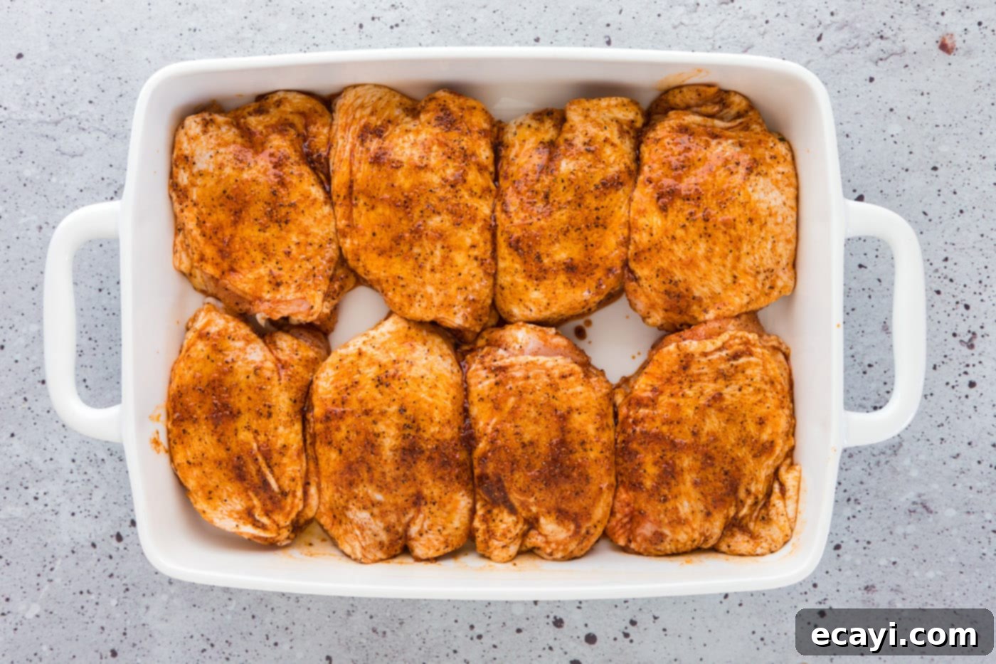 Golden Baked Chicken Thighs 7 seasoned chicken thighs in a baking dish