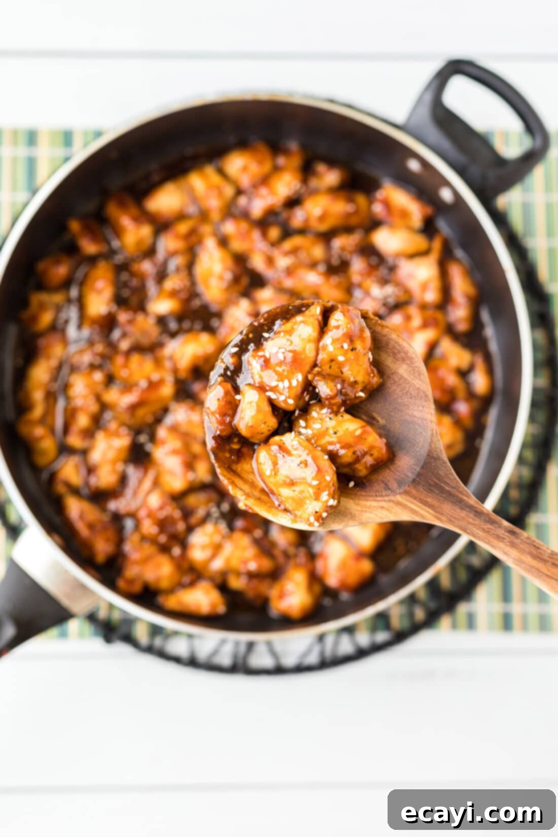 Crispy General Tso Chicken 3 Lifting a spoonful of General Tso Chicken with a sticky sauce