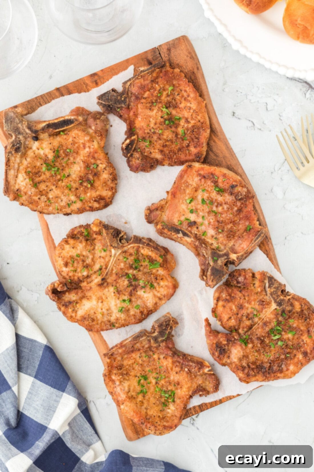 Golden Crispy Pork Chops 2 Platter of golden brown crispy pan-fried pork chops, ready to serve