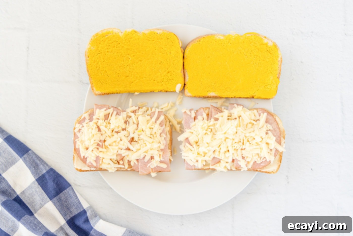 Sweet and Savory Monte Cristo Indulgence 6 shredded gruyere cheese on top of mayo and ham on bread