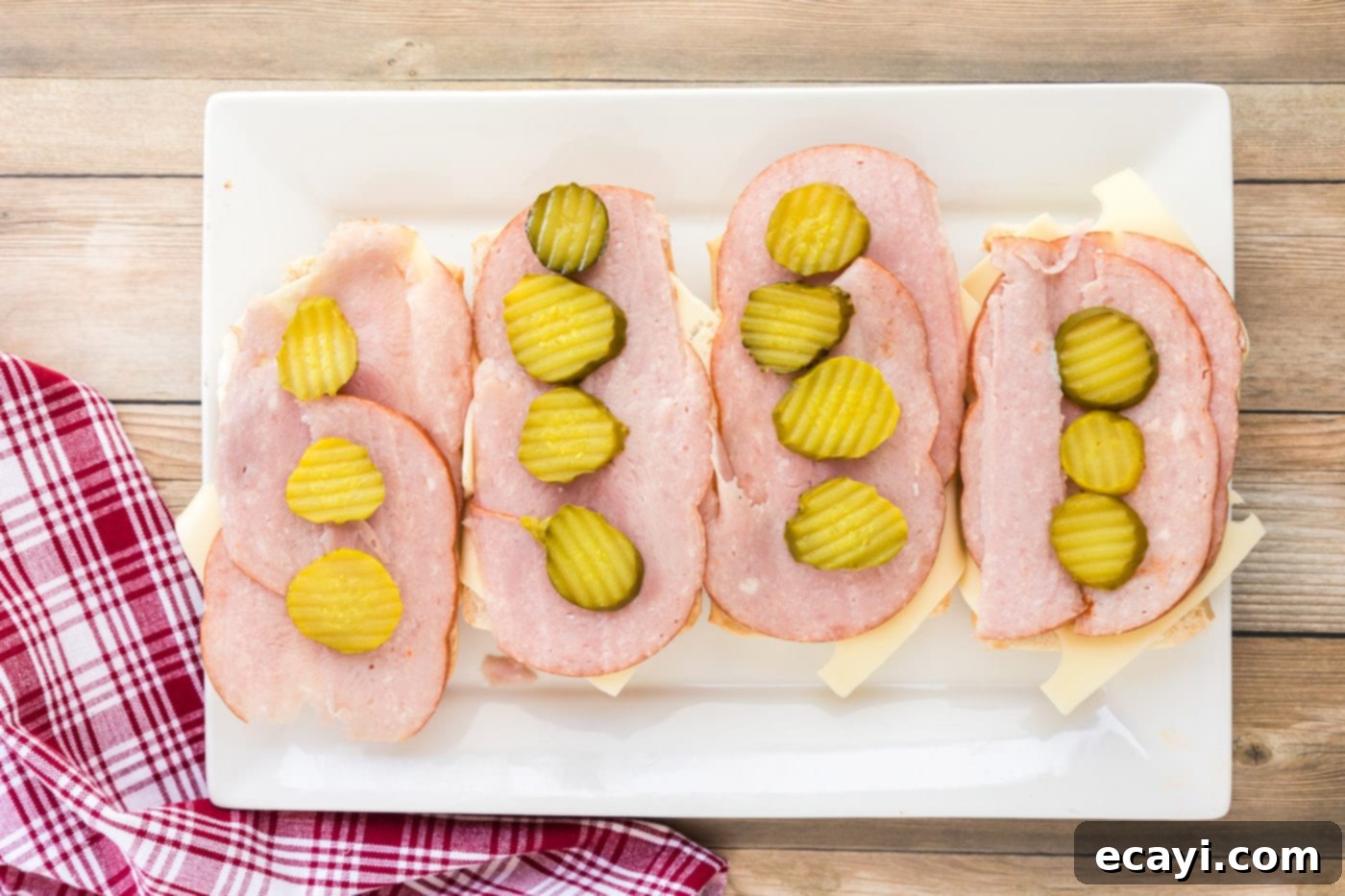 Cuban Sandwich: A Taste of Miami's Legacy 7 Pickle rounds on top of ham and Swiss cheese for Cubano