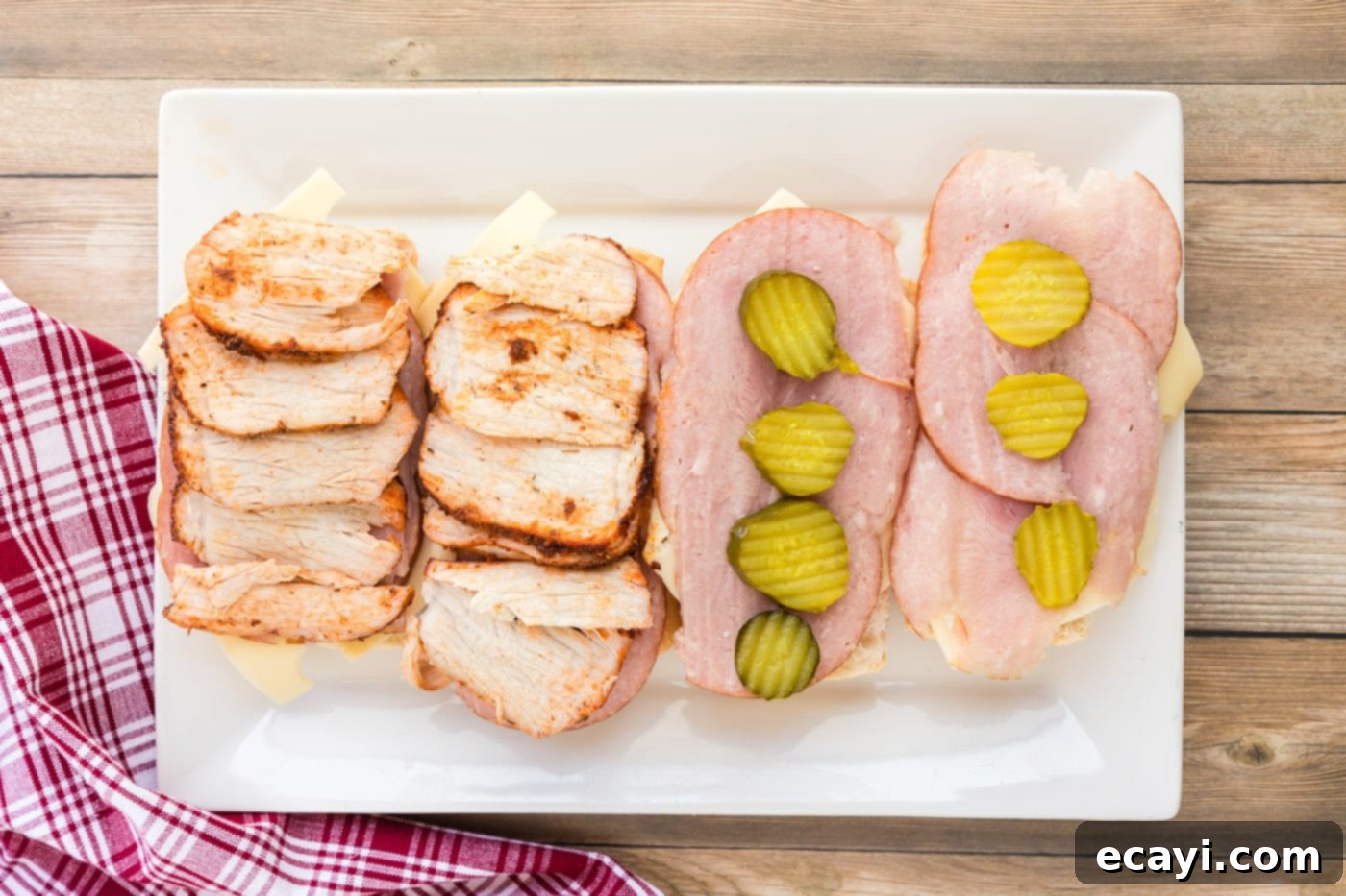 Cuban Sandwich: A Taste of Miami's Legacy 8 Pork tenderloin slices on top of cuban bread, ham, Swiss, and pickles