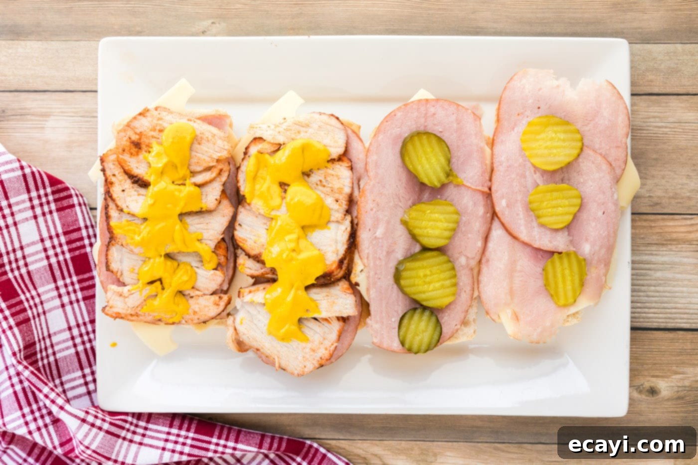 Cuban Sandwich: A Taste of Miami's Legacy 9 Cuban sandwich assembly with mustard