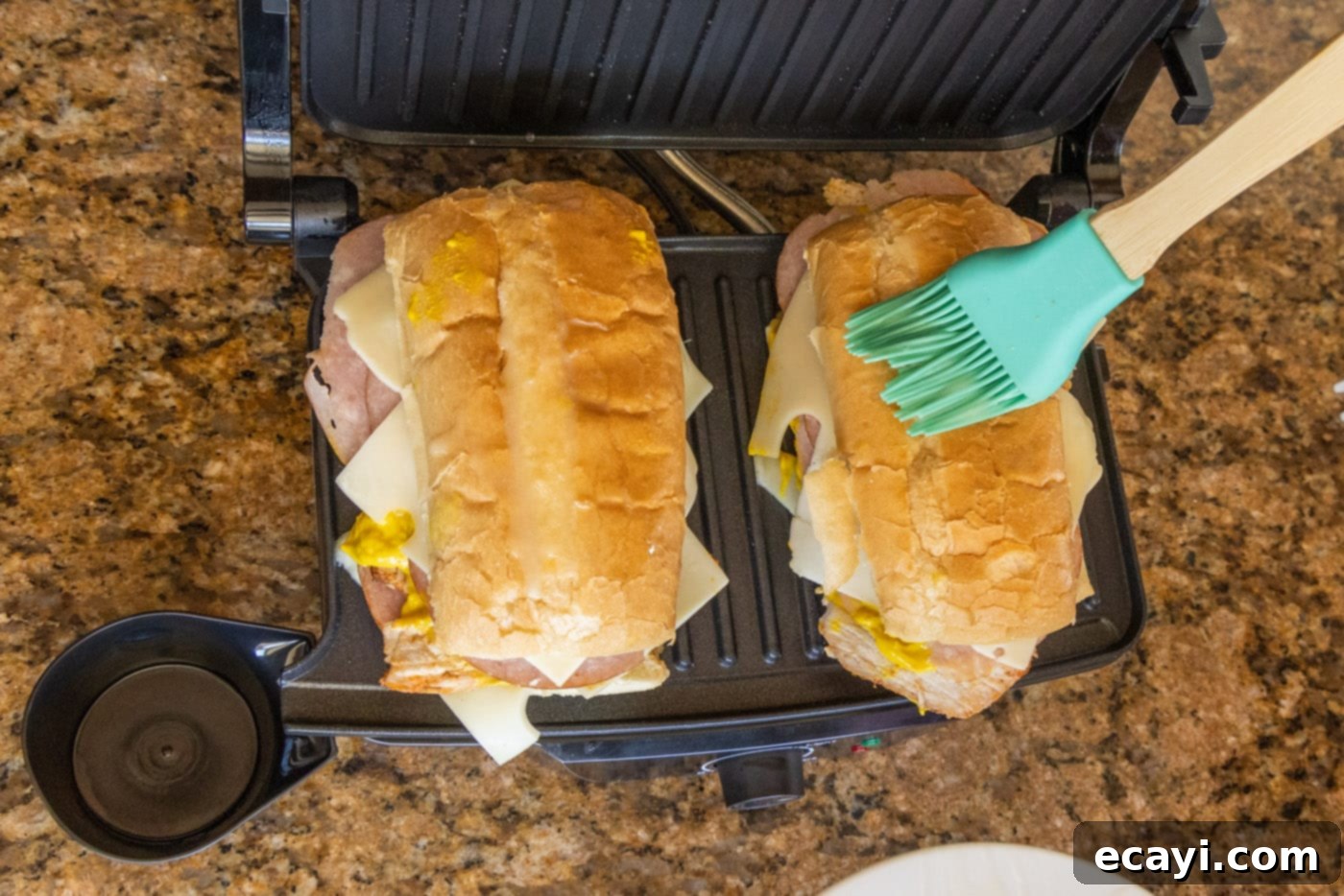 Cuban Sandwich: A Taste of Miami's Legacy 10 brushing the top of Cuban sandwich with butter