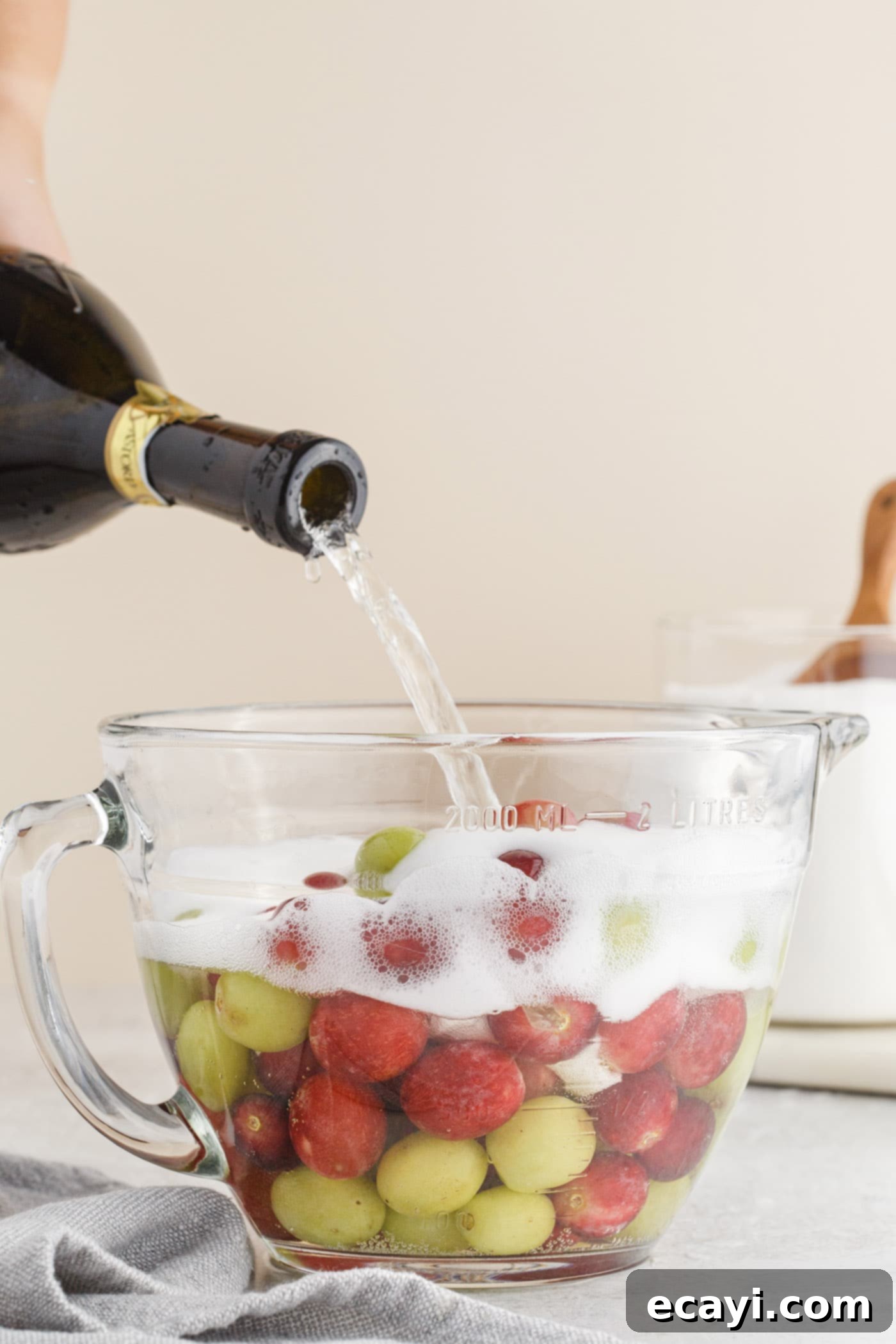 Prosecco Vodka Grape Fusion 5 pouring prosecco into a bowl of grapes