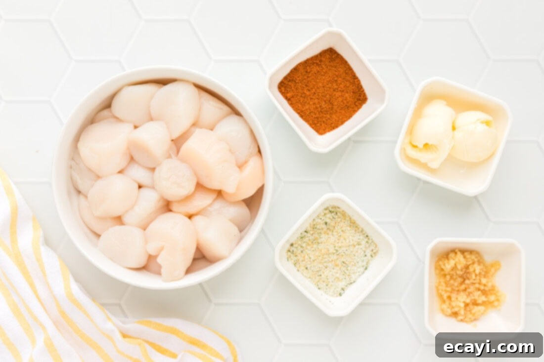 Perfect Air Fryer Scallops 4 ingredients for Air Fryer Scallops including raw scallops, Old Bay, garlic salt, butter, and minced garlic