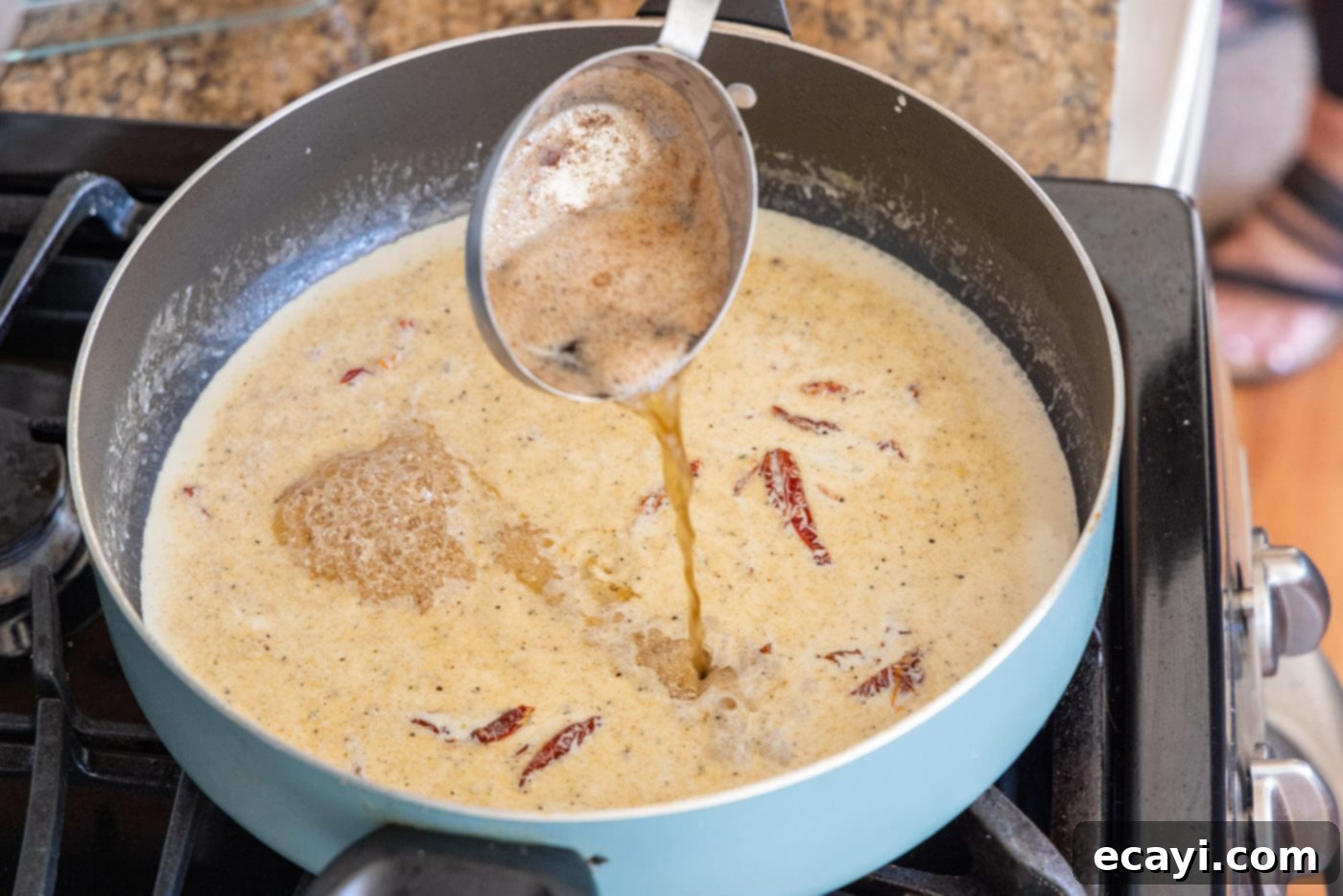 The Proposal Chicken 15 adding reserved butter and oil mixture to heavy cream in a skillet