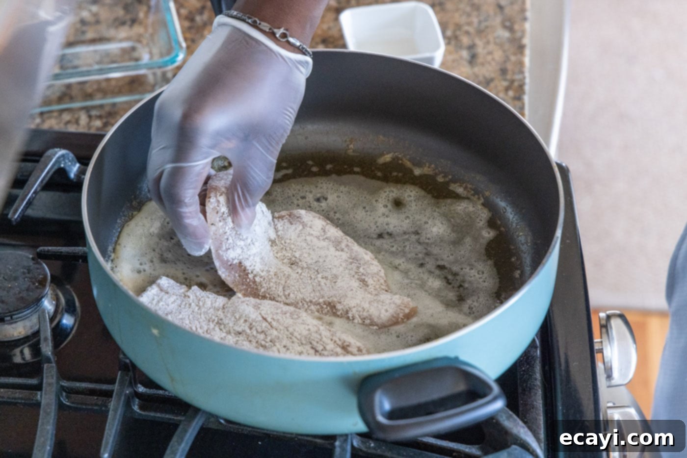 The Proposal Chicken 9 adding floured chicken breast to skillet