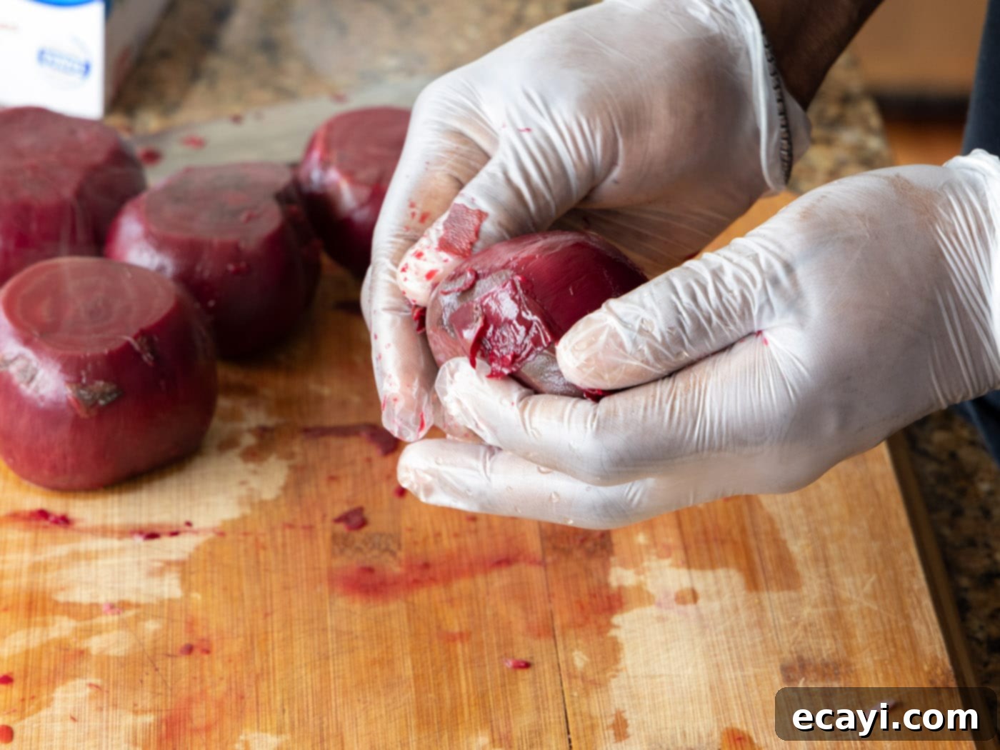 Caramelized Beet Perfection 5 A gloved hand effortlessly peeling the skin off a boiled beet, showing the vibrant red flesh beneath
