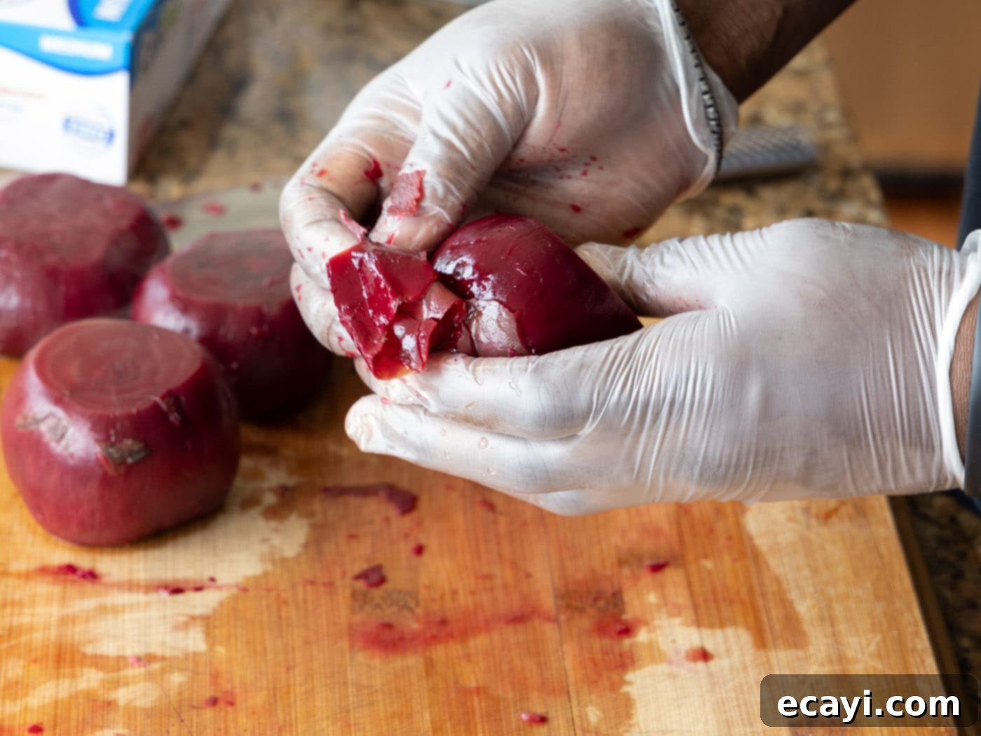 Caramelized Beet Perfection 6 Another image of gloved hands removing the soft skin from a cooked beet, demonstrating the ease of the process