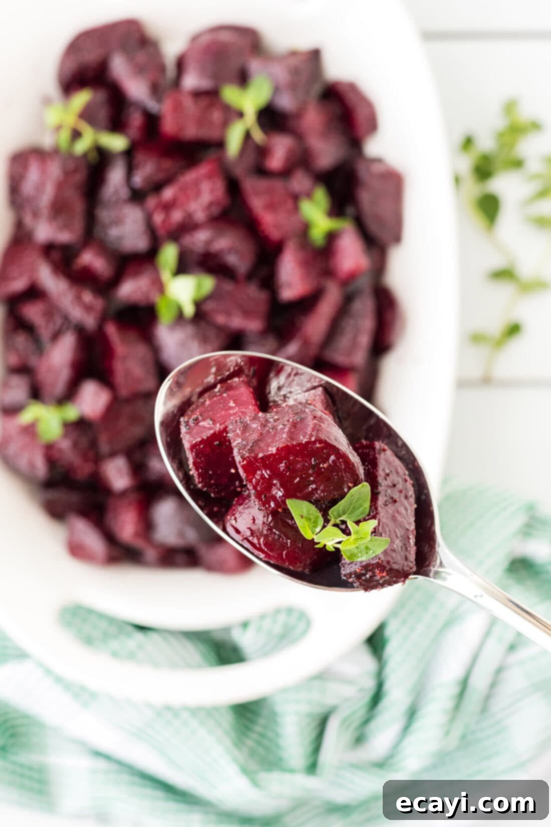 Caramelized Beet Perfection 8 A serving spoon lifting perfectly roasted beet chunks from a white dish, showcasing their rich color and tender texture