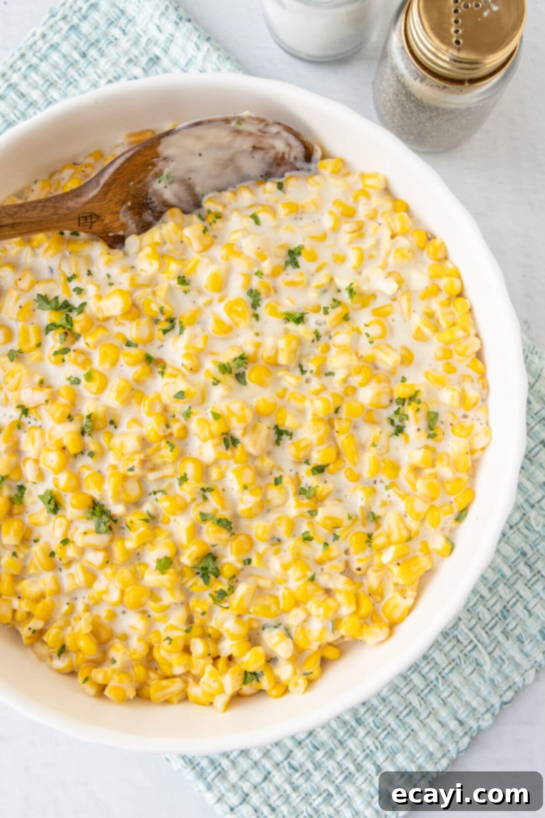 Golden Comfort Corn 2 bowl of creamy homemade creamed corn, garnished with fresh herbs