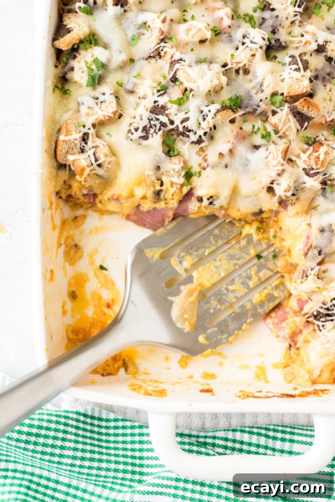 Ultimate Reuben Casserole Bake 2 A large pan filled with baked Reuben Casserole, showcasing layers of bread, corned beef, sauerkraut, and melted Swiss cheese, ready to be served family-style.
