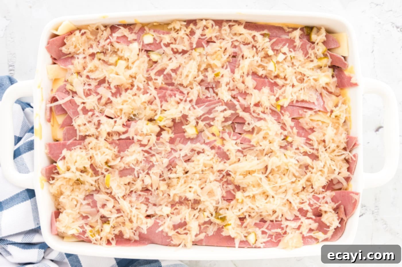 Ultimate Reuben Casserole Bake 15 The final layer of sauerkraut and pickle mixture spread over the second layer of corned beef.