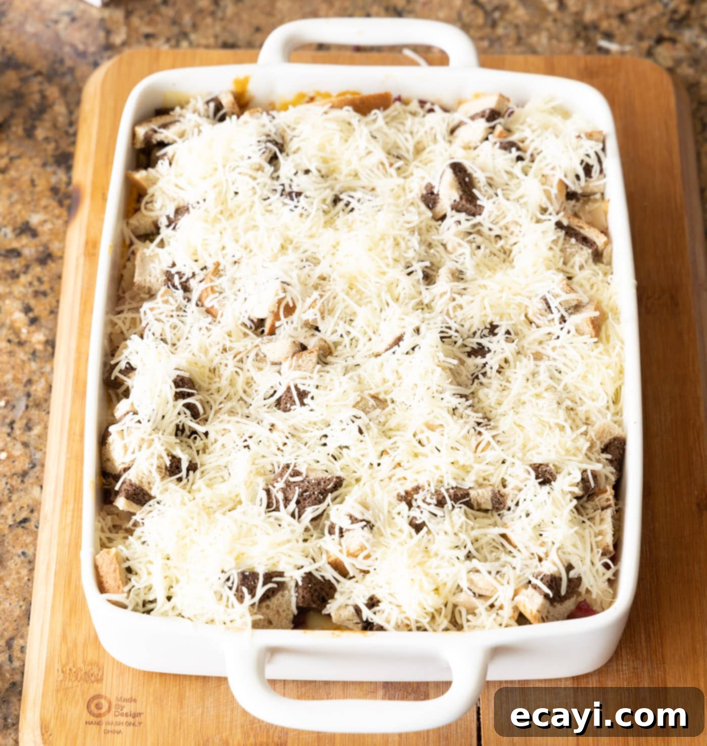 Ultimate Reuben Casserole Bake 18 Shredded Swiss cheese generously sprinkled over the top layer of bread cubes on the Reuben casserole before its final bake.