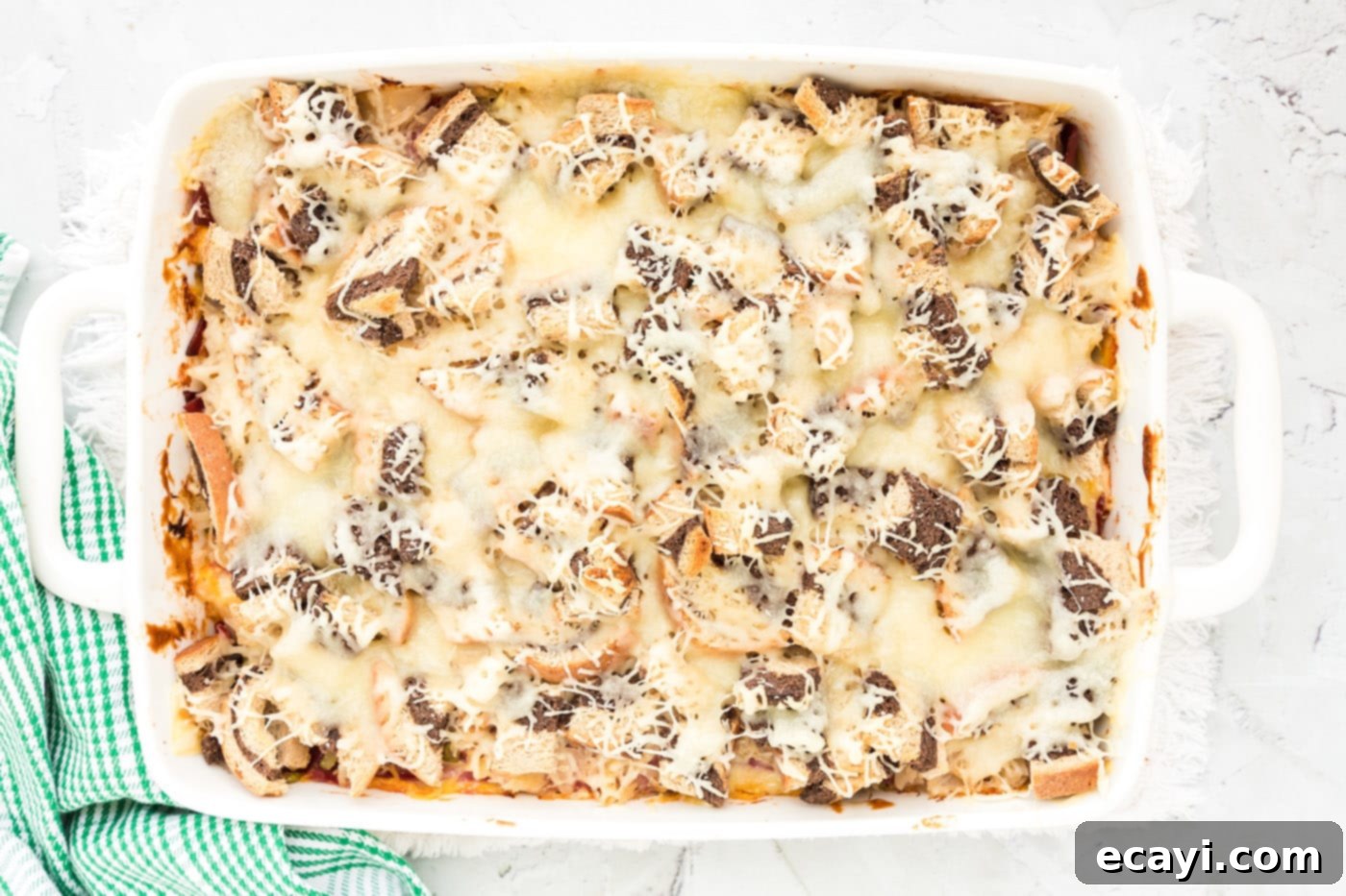 Ultimate Reuben Casserole Bake 19 The finished, golden-brown Reuben casserole in a baking dish, fresh out of the oven, with melted and bubbly Swiss cheese on top.