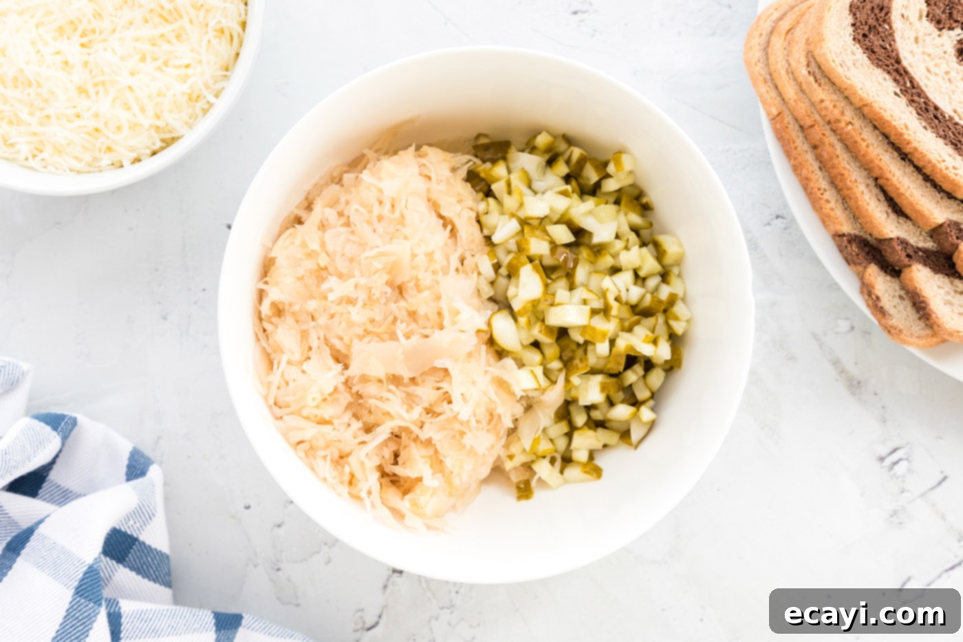 Ultimate Reuben Casserole Bake 7 A bowl filled with a mixture of drained sauerkraut and finely chopped pickles.