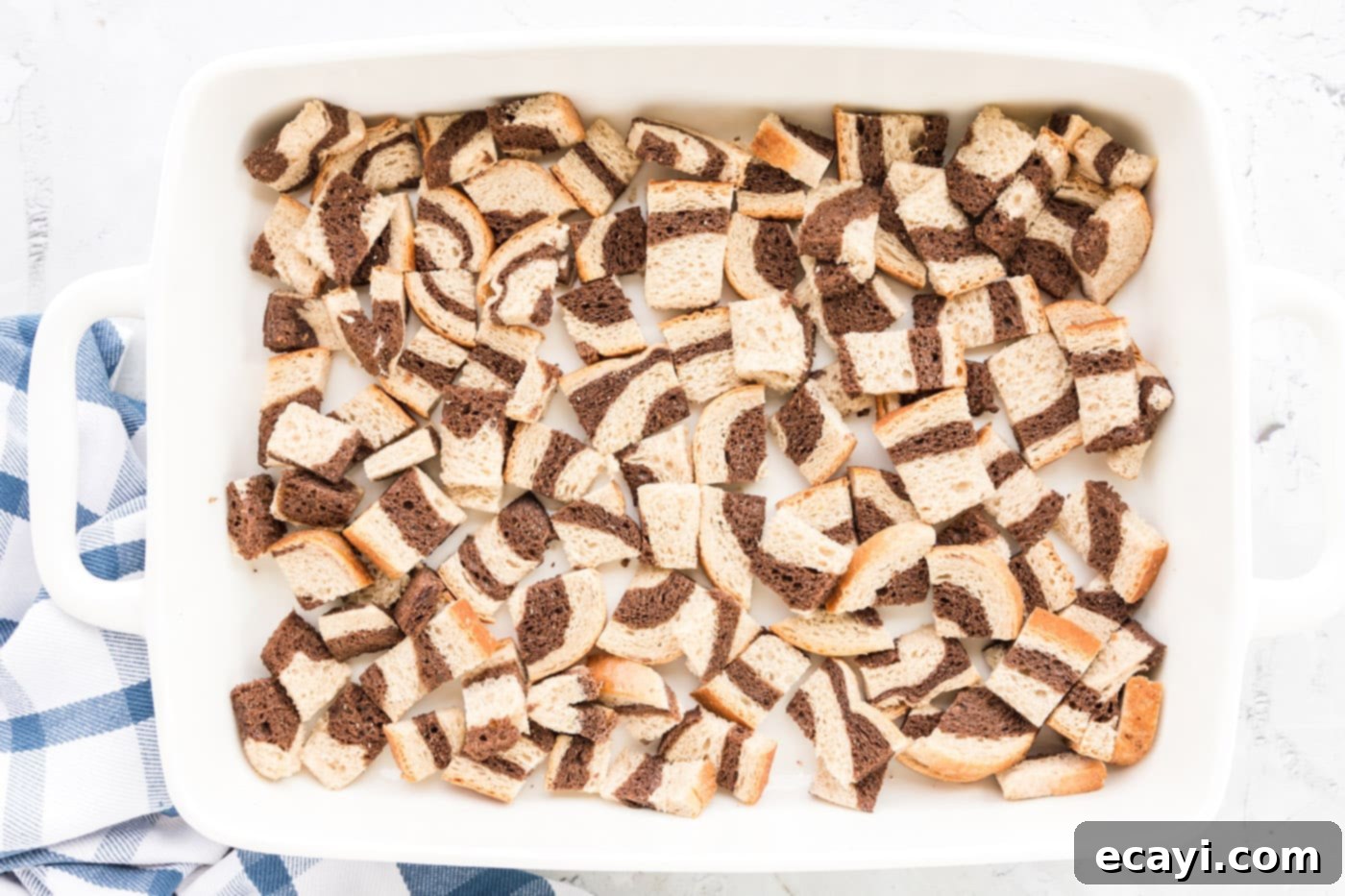 Ultimate Reuben Casserole Bake 9 The first layer of cubed rye bread evenly spread at the bottom of a 13x9 inch baking dish.