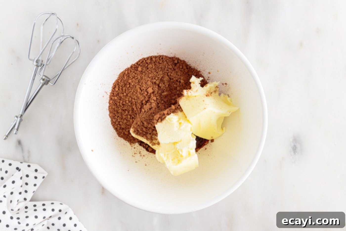 Velvet Moisture Cake 9 softened butter and cocoa powder expertly combined in a mixing bowl for the frosting
