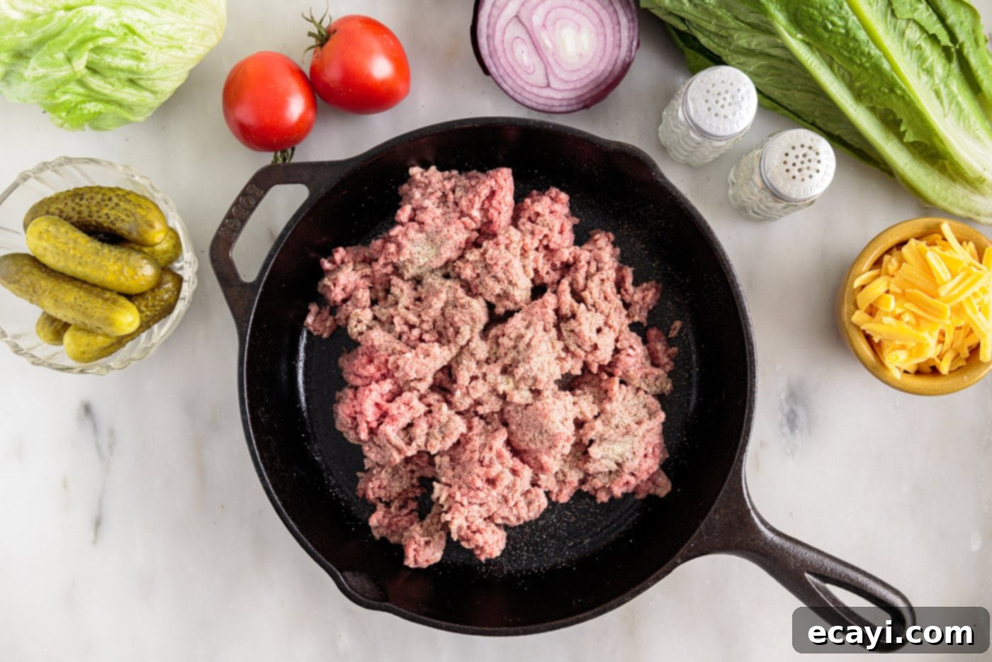 Deconstructed Big Mac Salad 5 browning ground beef in a skillet, seasoned with salt, pepper, and onion powder