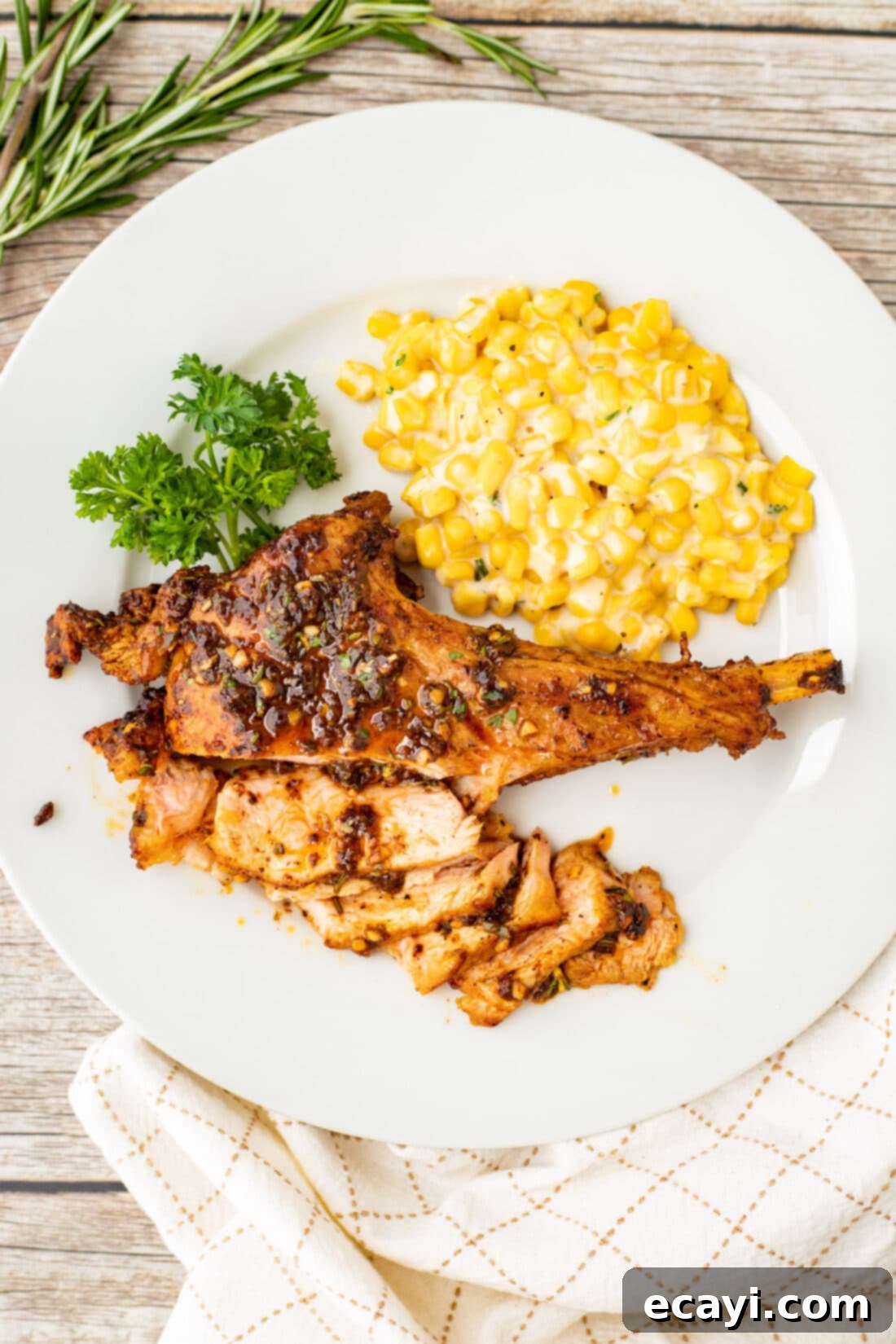 Succulent Veal Chops 15 A beautifully plated veal chop with a side of creamy corn, garnished with fresh herbs, showcasing a complete and appealing meal.