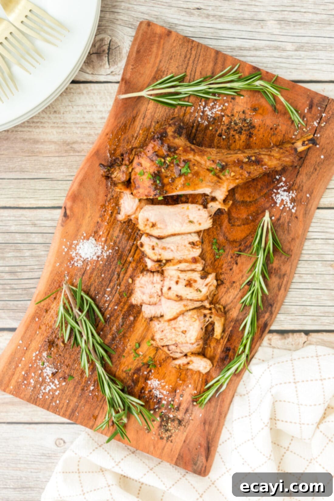 Succulent Veal Chops 3 A perfectly cooked veal chop resting on a wooden cutting board, showcasing its internal tenderness and the golden crust.