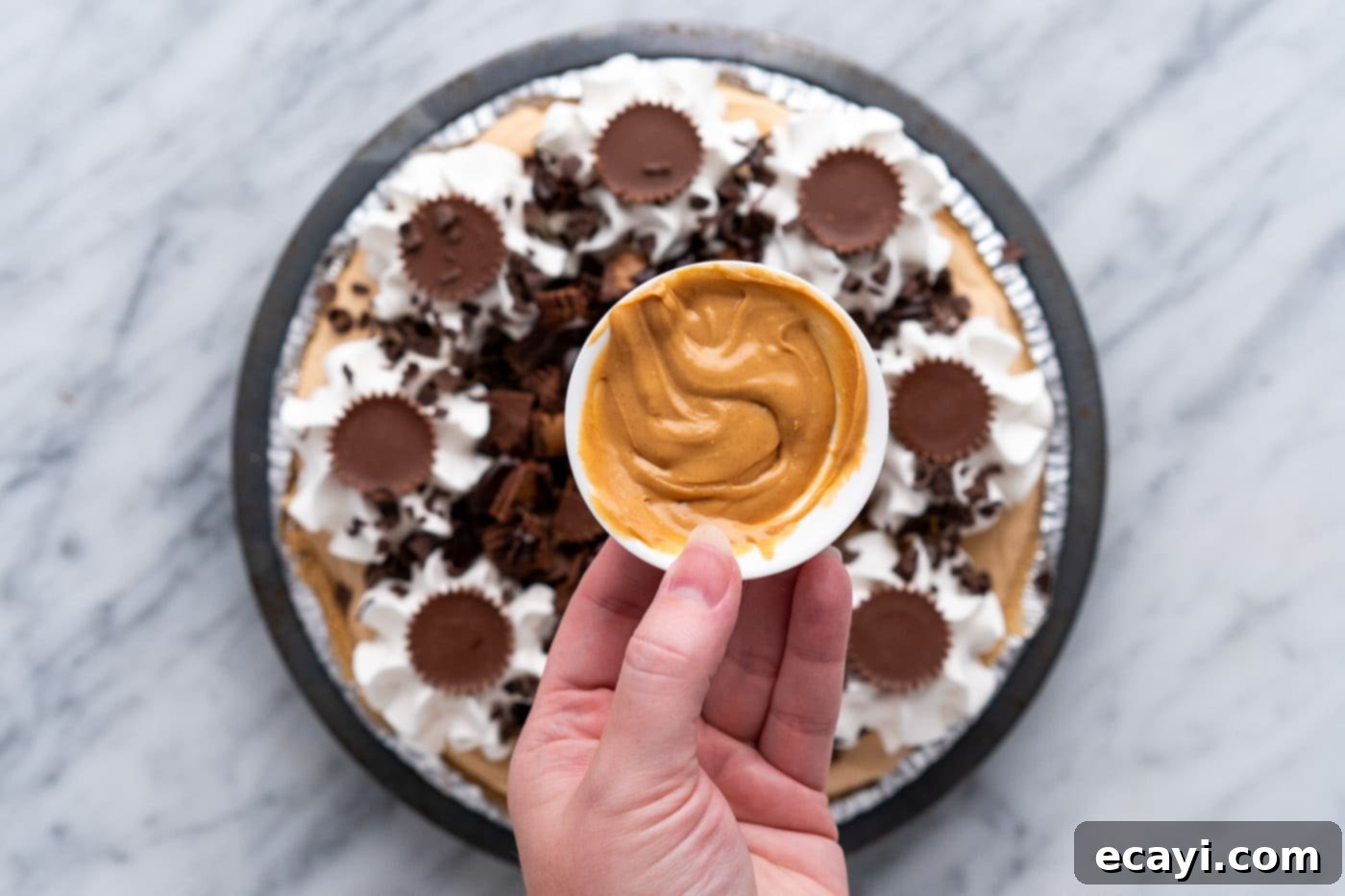 Peanut Butter Perfection Pie 17 melted peanut butter held over the top of Reeses pie
