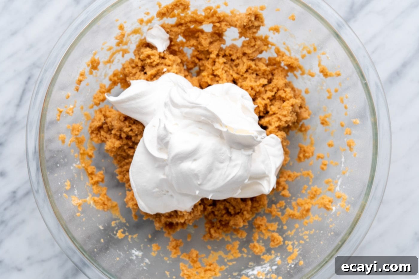 Peanut Butter Perfection Pie 8 cool whip added to peanut butter mixture in a bowl