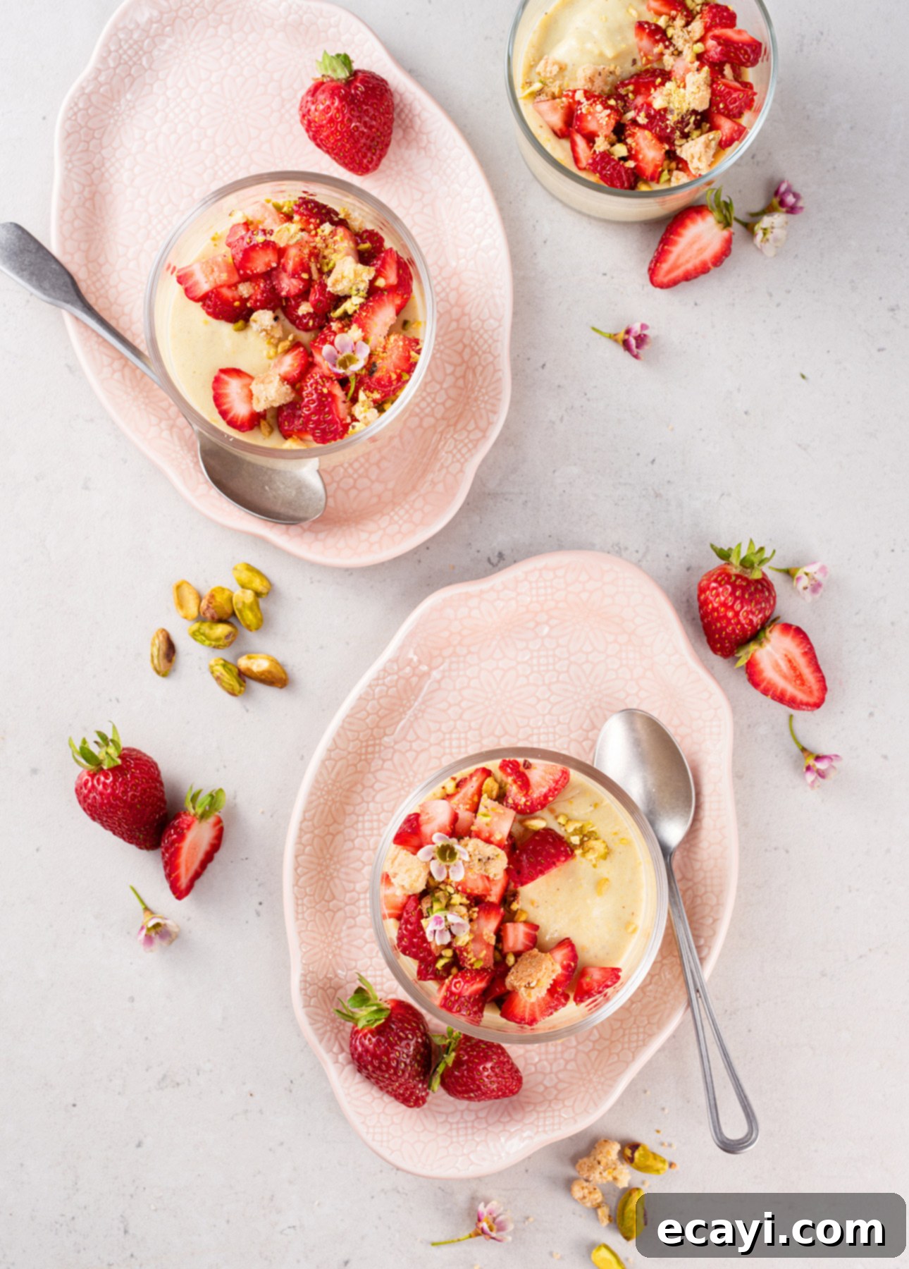 Strawberry Kissed Pistachio Delights 3 Close-up of Pistachio Pudding with Macerated Strawberries in a glass, ready for enjoyment // FoodNouveau.com