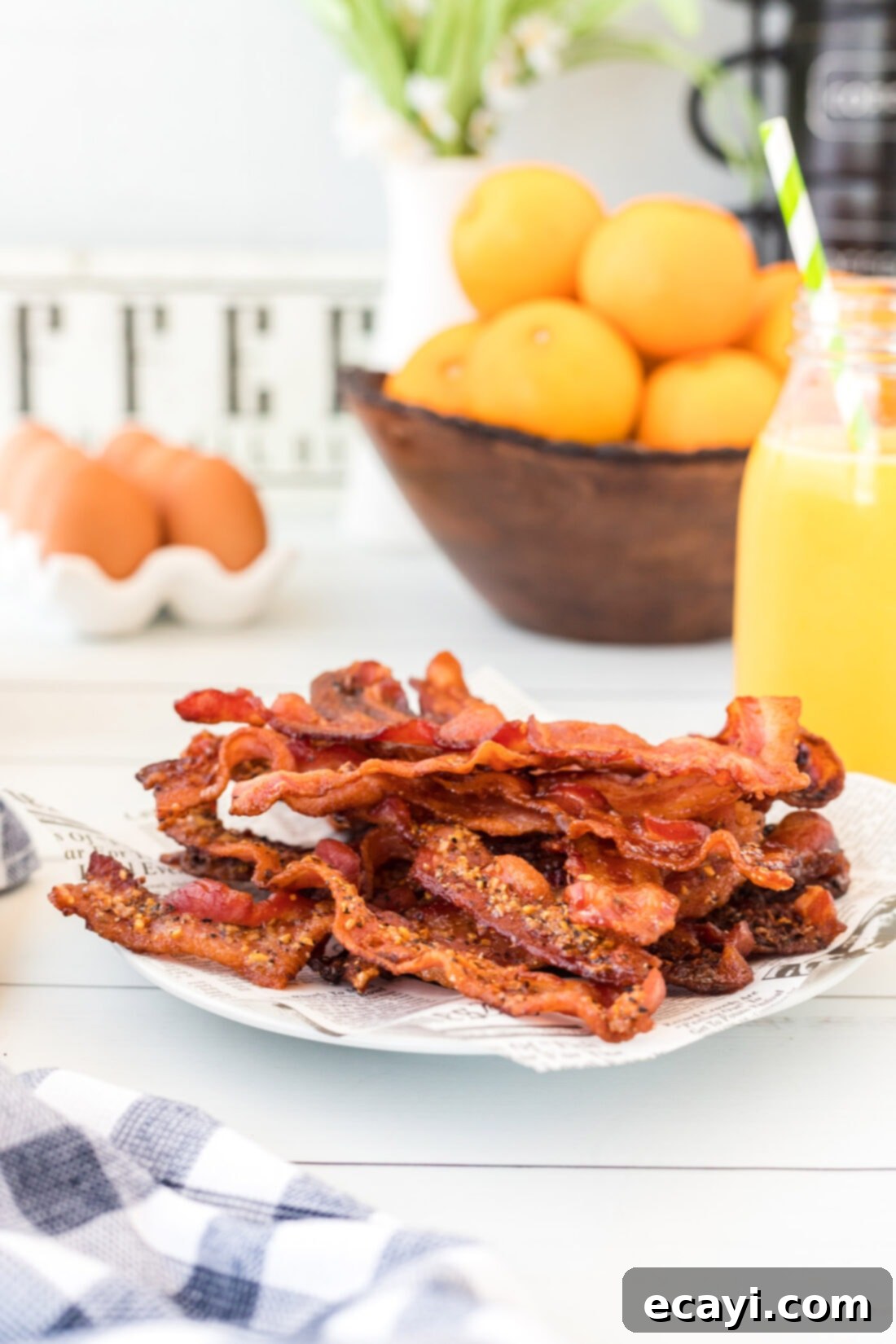 Perfect Crispy Oven Bacon 7 Close-up of a plate of perfectly crispy, golden-brown oven-made bacon, ready to be served