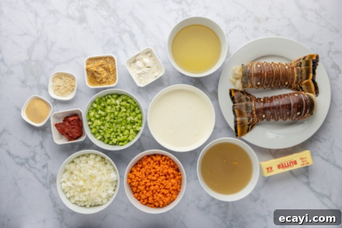 Rich Lobster Bisque 4 A flat lay image showing all the fresh ingredients needed for homemade lobster bisque: lobster tails, butter, garlic, vegetables, tomato paste, wine, stock, and cream.