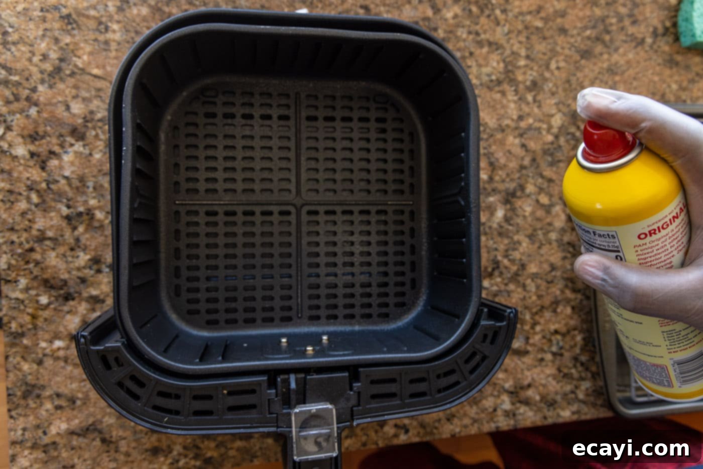Crispy Air Fryer Coconut Shrimp 11 spraying air fryer with cooking spray