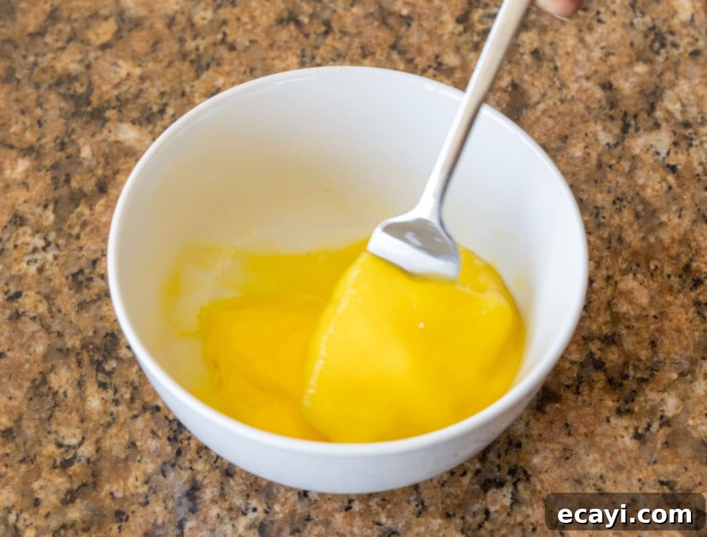 Crispy Air Fryer Coconut Shrimp 5 whisking eggs in a bowl with a fork