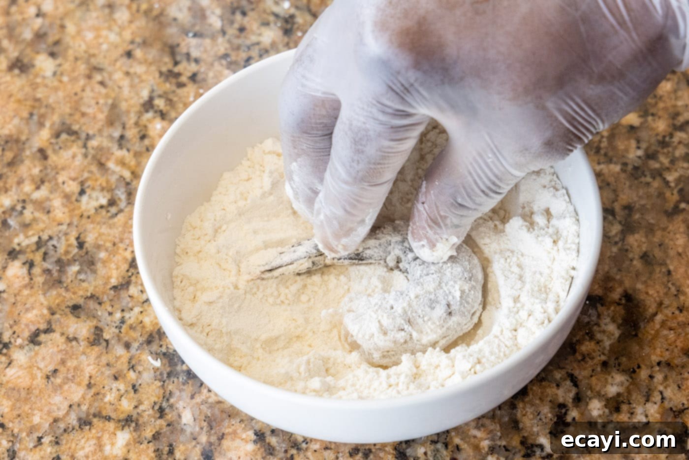 Crispy Air Fryer Coconut Shrimp 6 dipping shrimp into flour