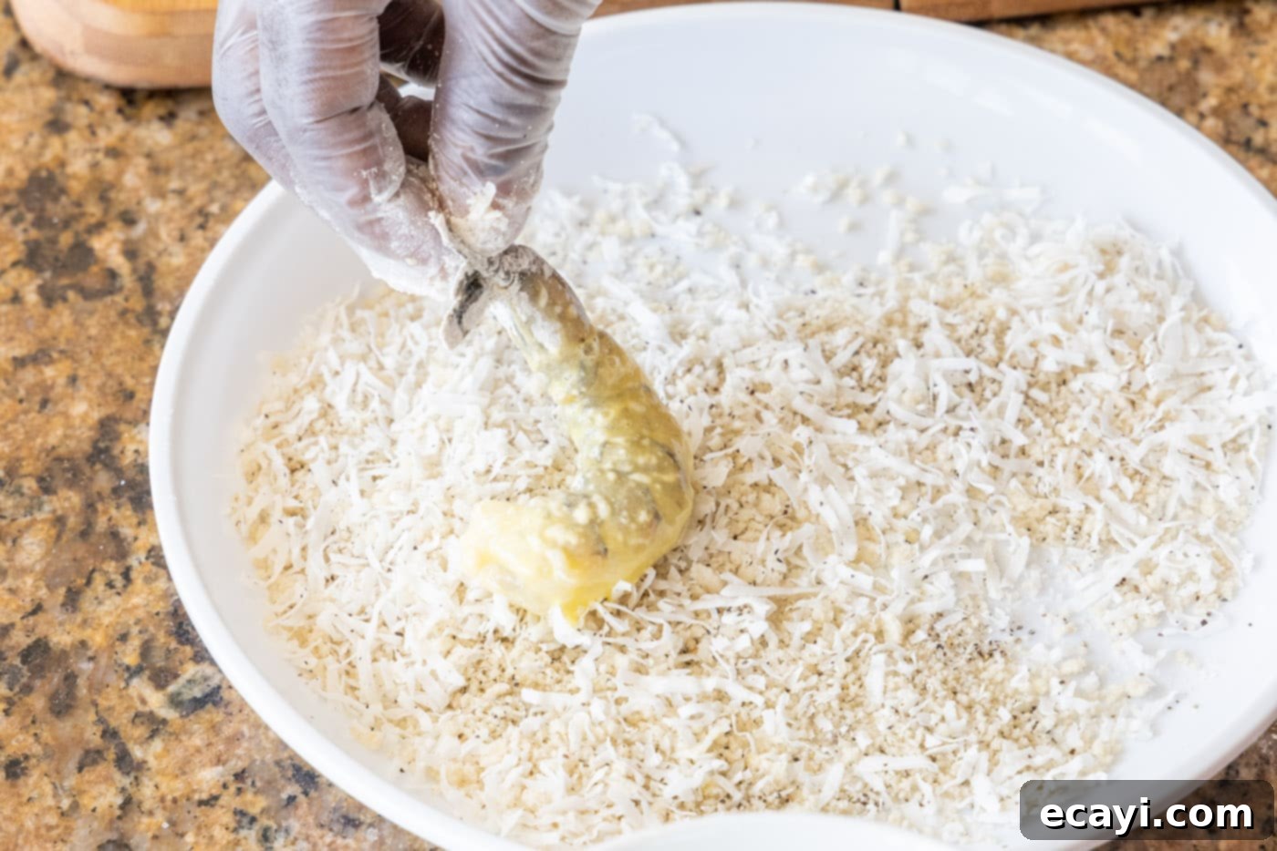 Crispy Air Fryer Coconut Shrimp 8 pressing flour and egg coated shrimp into coconut and breadcrumbs