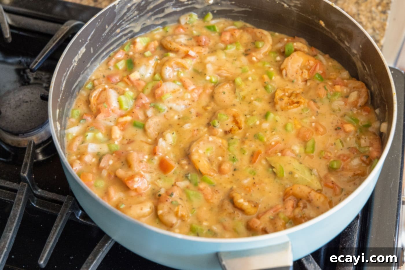 Authentic Cajun Shrimp Etouffee 12 A close-up of the finished shrimp etouffee simmering gently in a skillet, with vibrant colors and rich texture.