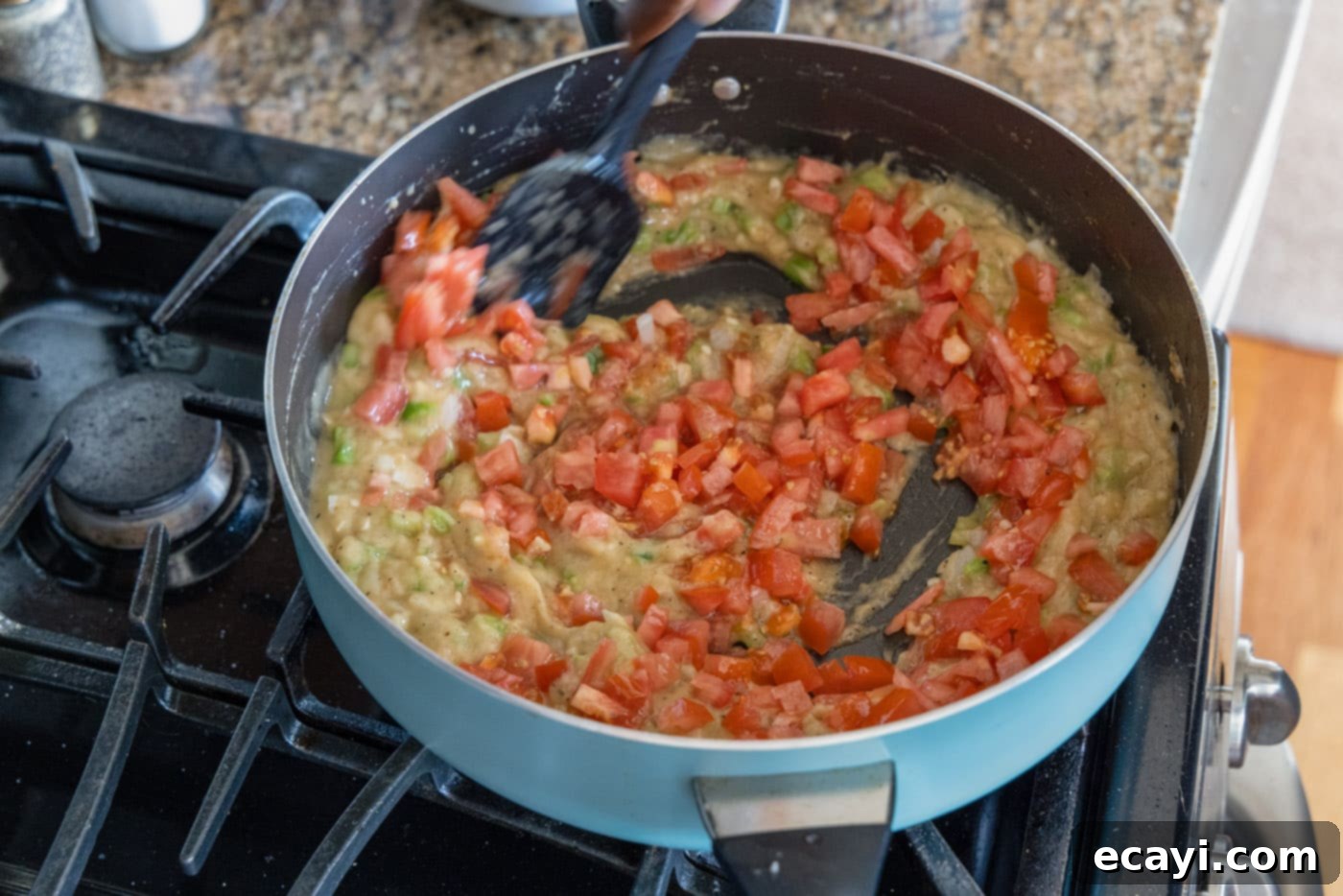 Authentic Cajun Shrimp Etouffee 10 Chopped fresh tomatoes added to the simmering etouffee gravy in a skillet.