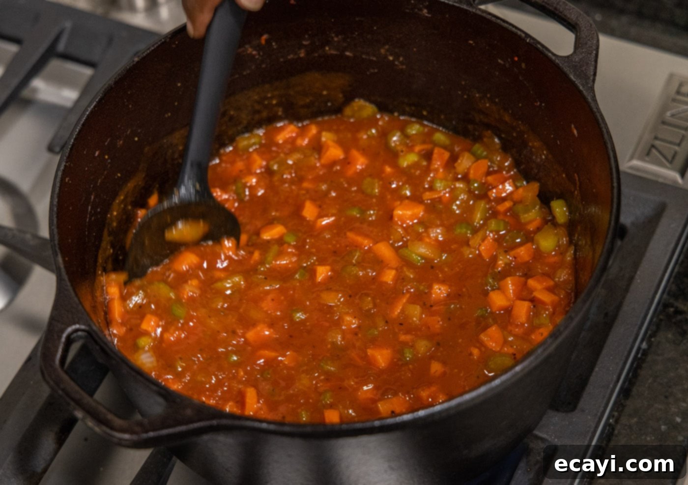 Exquisite Veal Osso Buco 13 stirring the veal osso buco liquid in the dutch oven