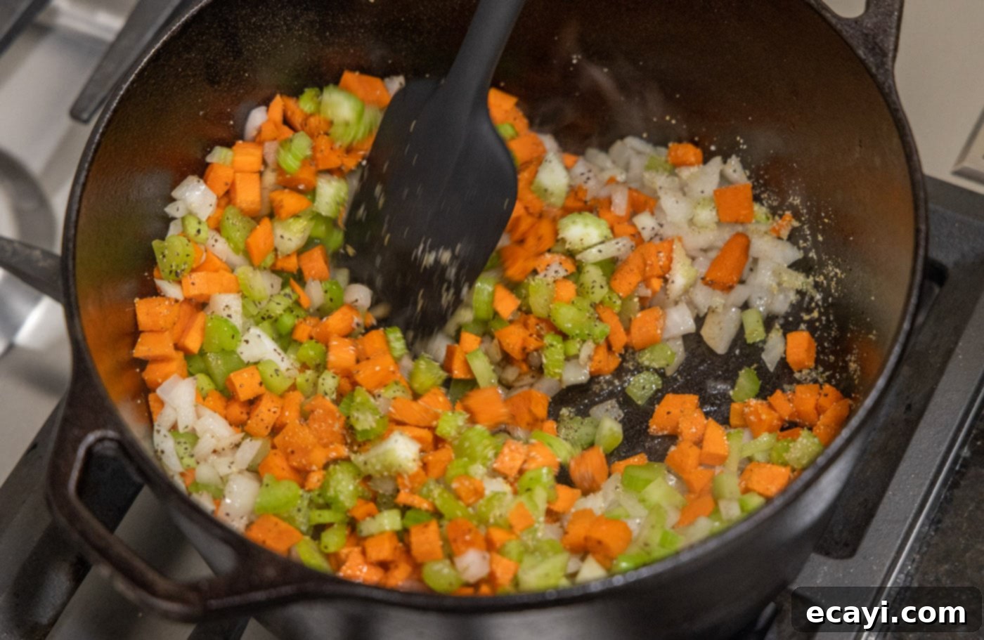 Exquisite Veal Osso Buco 9 cooking onion, celery, and carrots in a pan to soften and release aromas