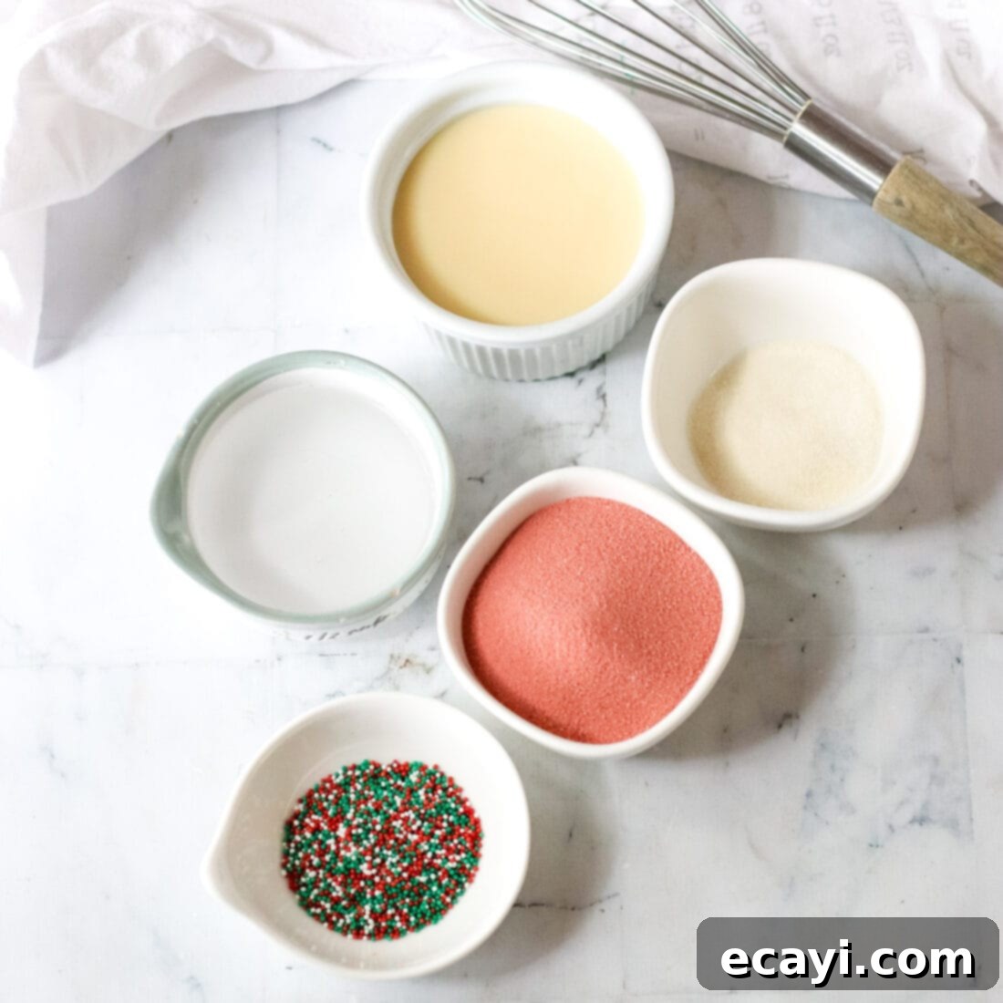 Peppermint Swirl Shooters 4 A collection of ingredients laid out for making Candy Cane Jello Shots, including jello packets, vodka, and condensed milk.