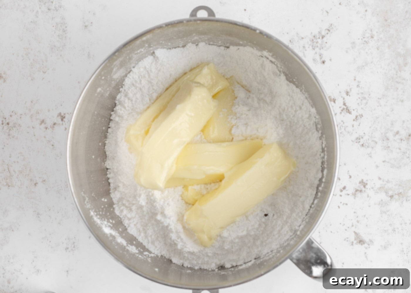 Crystalline Dream Cake 15 Butter and powdered sugar in a bowl of a stand mixer, beginning to combine for buttercream.