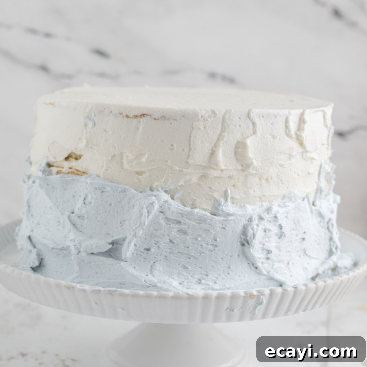 Crystalline Dream Cake 20 Demonstration of how to frost an ombre effect on a tiered cake, blending blue and white.