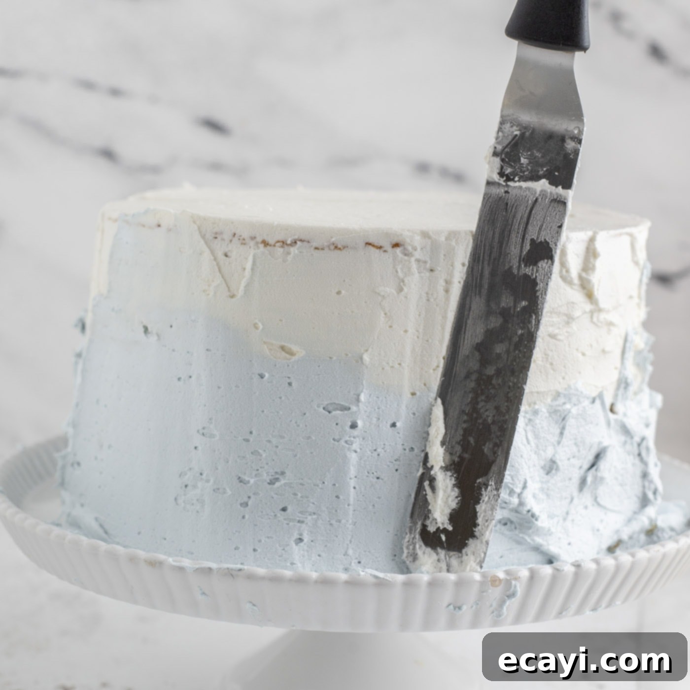 Crystalline Dream Cake 21 Frosting a tiered cake in ombre colors, showing the completed blended effect.